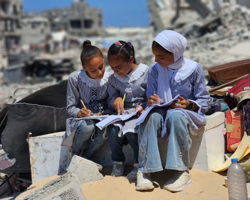 KHAN YUNIS, GAZA - SEPTEMBER 03: Students do homeworks after the lessons at their tent school, in which their teacher Alaa Abu Mustafa, whose house was destroyed in the Israeli army's attacks, gives them education in Khan Yunis, Gaza on September 03, 2024. The tent school was built on the rubble of the destroyed house of the teacher. Despite the limited and difficult conditions, teacher Alaa strives to ensure that primary school students are not deprived of education. ( Hani Alshaer - Anadolu Agency )