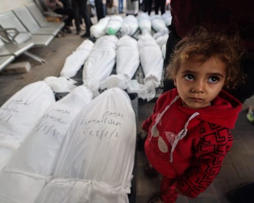 EDITORS NOTE: Graphic content / A child stands near the bodies of family members of "Ayman Nofal, or "Abu Ahmad", a member of the Hamas general military council and commander of the central command in Al-Qassam Brigades, after they were killed the previous day during Israeli bombardment, on January 10, 2024 at al Najar hospital in Rafah in the Gaza Strip. (Photo by AFP)