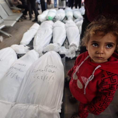 EDITORS NOTE: Graphic content / A child stands near the bodies of family members of "Ayman Nofal, or "Abu Ahmad", a member of the Hamas general military council and commander of the central command in Al-Qassam Brigades, after they were killed the previous day during Israeli bombardment, on January 10, 2024 at al Najar hospital in Rafah in the Gaza Strip. (Photo by AFP)