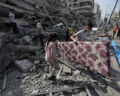 Palestinians inspect the ruins of Aklouk Tower destroyed in Israeli airstrikes in Gaza City on October 8, 2023. The death toll from the devastating Israeli war on the Gaza Strip has risen to 313 since early yesterday morning, with more than 1,990 others injured, according to medical sources. Photo by Naaman Omar apaimages