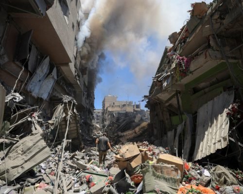 Smoke rises as a Palestinian man inspects the site of Israeli strikes on buildings at Gaza's Old City market, in Gaza City July 9, 2025. REUTERS/Dawoud Abu Alkas     TPX IMAGES OF THE DAY