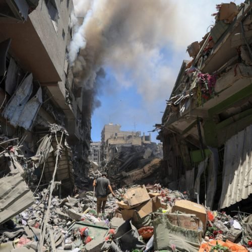 Smoke rises as a Palestinian man inspects the site of Israeli strikes on buildings at Gaza's Old City market, in Gaza City July 9, 2025. REUTERS/Dawoud Abu Alkas     TPX IMAGES OF THE DAY