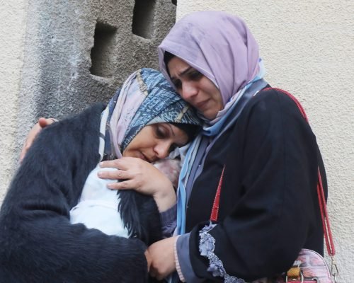 Relatives of the Palestinians died in Israeli attacks, mourn as they receive the dead bodies from the morgue of Al-Aqsa Hospital for burial in Dair El-Balah, Gaza Strip, 18 February 2024. Photo by Omar Ashtawy apaimages